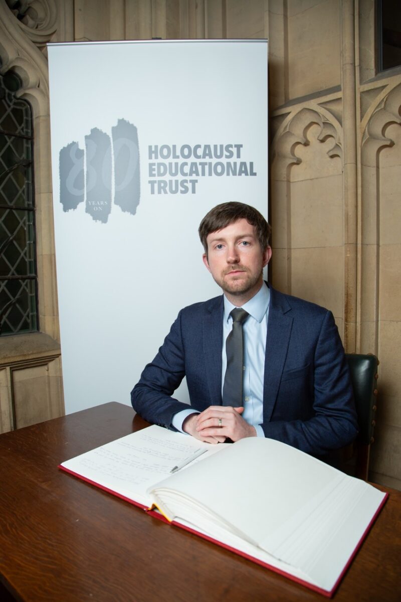 Dan signing the Holocaust Educational Trust Book of Commitment